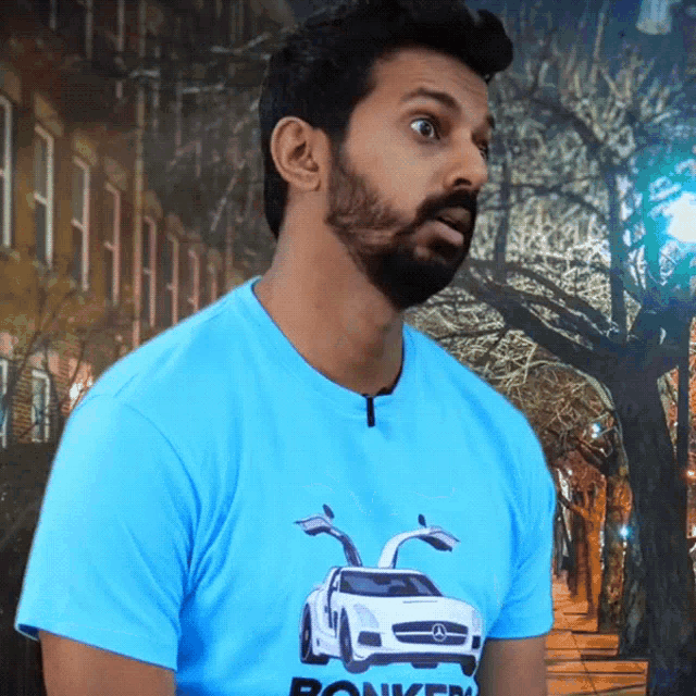 a man wearing a blue shirt that says bonkers