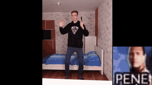 a man in a black sweatshirt is dancing in front of a bed with the word pene in the corner