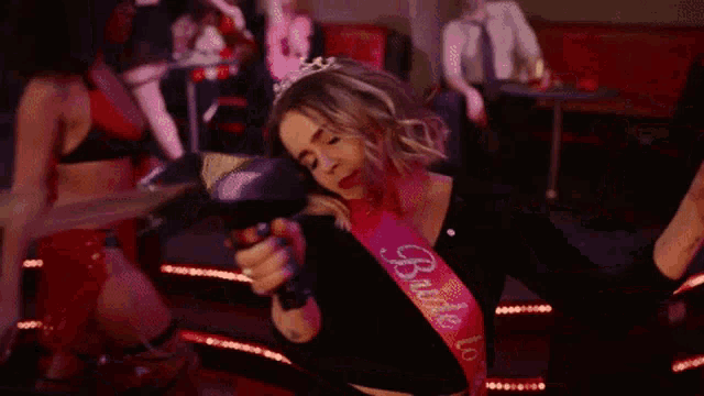 a woman wearing a sash that says bride to be