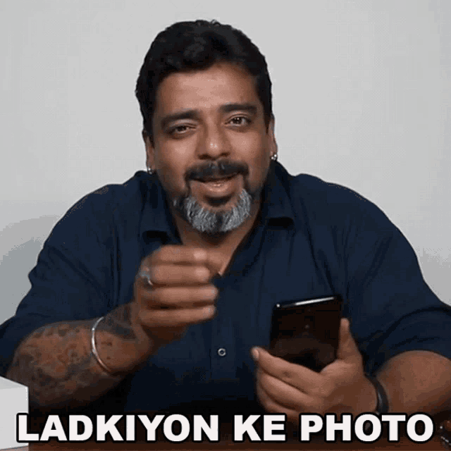 a man holding a cell phone with the words ladkiyon ke photo above him