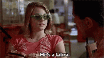 a woman wearing sunglasses is talking to a man in a restaurant .