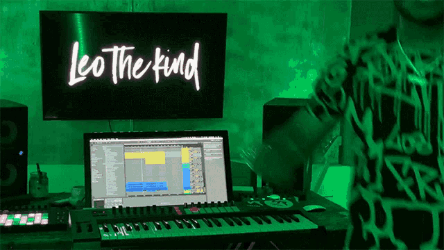 a neon sign that says leo the kind is above a keyboard