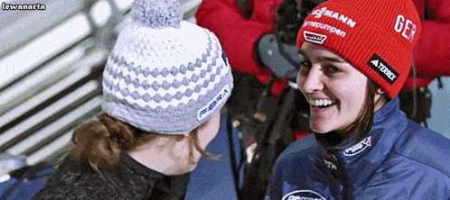 a woman wearing a red beanie that says gfe on it