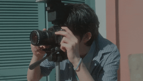 a man taking a photo with a canon camera