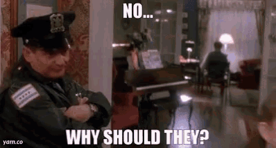 a police officer is standing in a living room with a piano in the background .