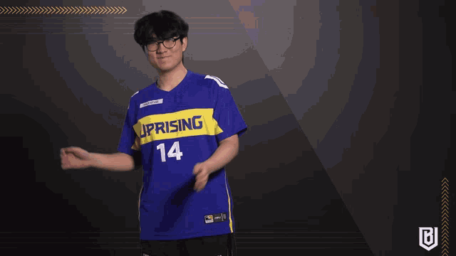 a man wearing a blue jersey that says uprising 14