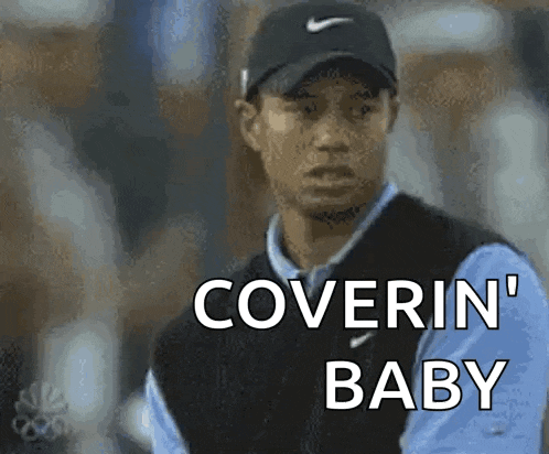 a man wearing a hat and vest says coverin ' baby .