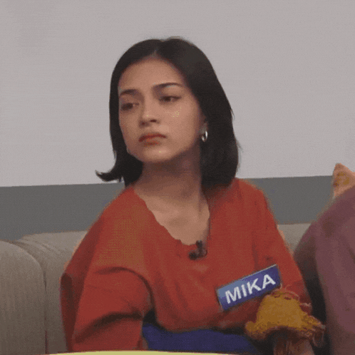 a woman with a name tag that says mika on it
