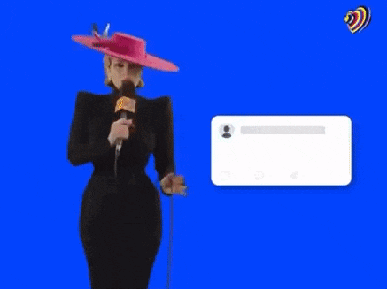 a woman in a pink hat is holding a microphone and a tweet that says mother has arrive .