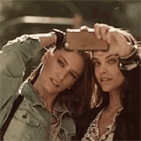 two women are taking a selfie with their cell phone