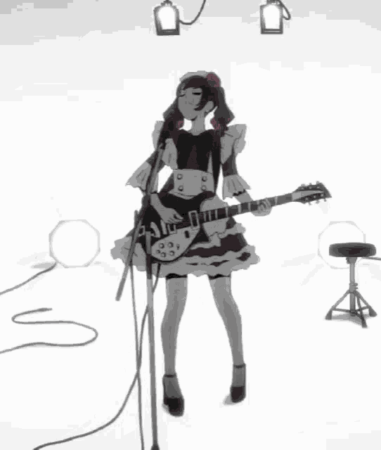 a girl in a maid outfit is singing into a microphone while playing a guitar