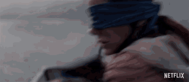 a blurry picture of a person with a blindfold and the word netflix on the bottom