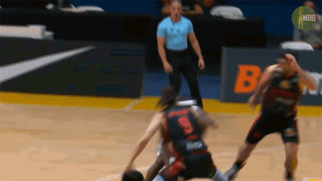 a basketball game is being played in front of an ad for nbc