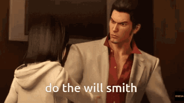 a man in a suit and red shirt is talking to a woman in a white hoodie