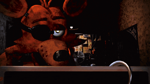 a cartoon fox wearing sunglasses is looking at a computer screen