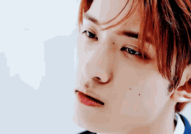 a close up of a man 's face with red hair