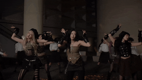 a group of young women are dancing in a room