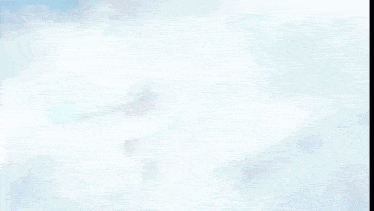 a white feather is floating in the air on a dark background .