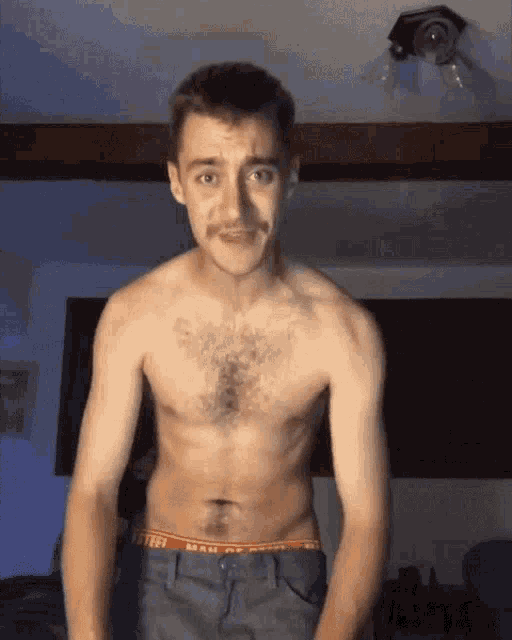 a shirtless man with a mustache is wearing a pair of underwear that says man on the inside