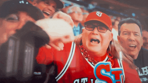 a woman in a chicago bulls jersey is surrounded by other people