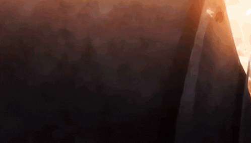a dark background with a few trees in the distance
