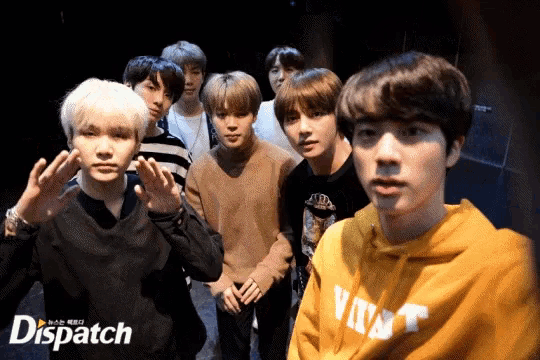 a group of young men are posing for a photo with dispatch in the corner