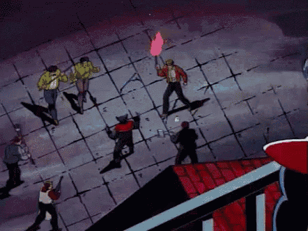 a group of people standing on top of a building with a torch