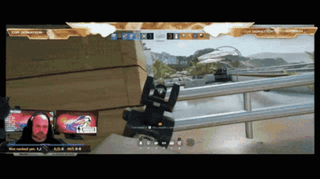 a man is playing a video game with a top donation banner