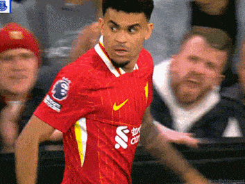 a soccer player wearing a red jersey with a nike logo