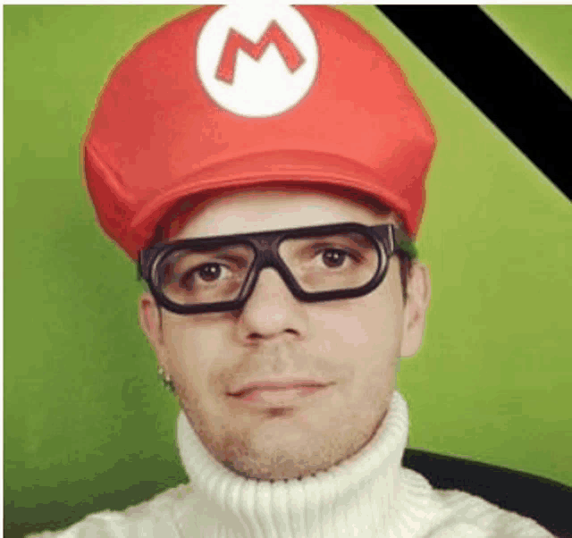 a man wearing a red hat and glasses is taking a selfie .