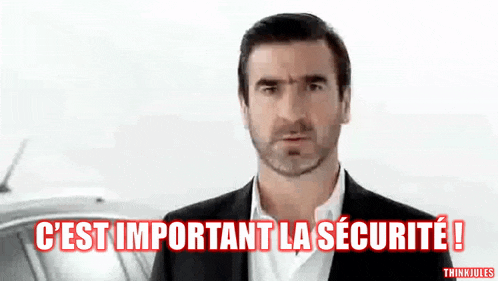 a man with a beard is standing in front of a sign that says " c'est important la securite "