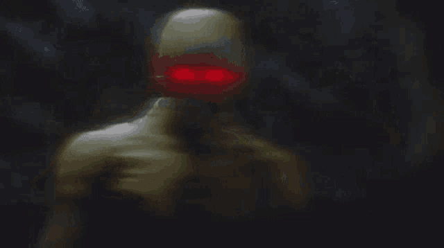 a blurred image of a man with red eyes