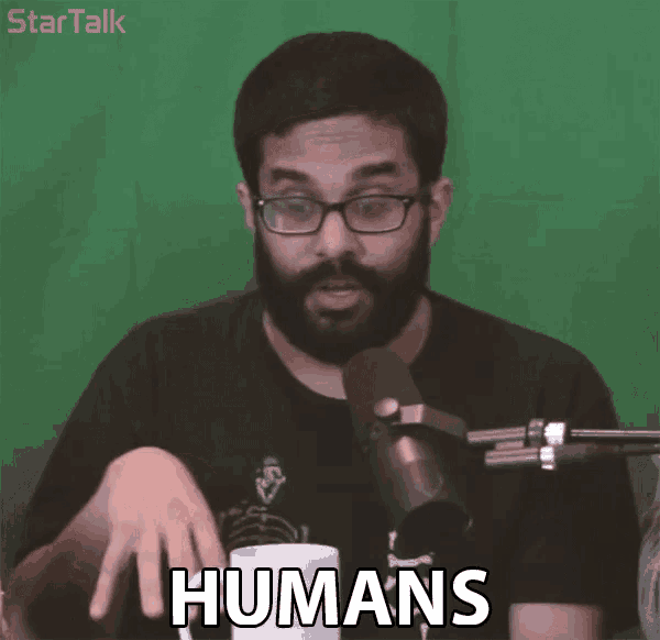 a man in front of a green screen says humans