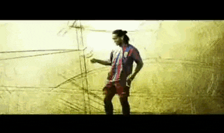 a soccer player is standing in front of a yellow wall