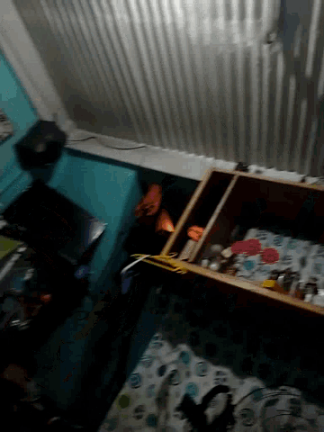 a blurred image of a room with a couch and a shelf