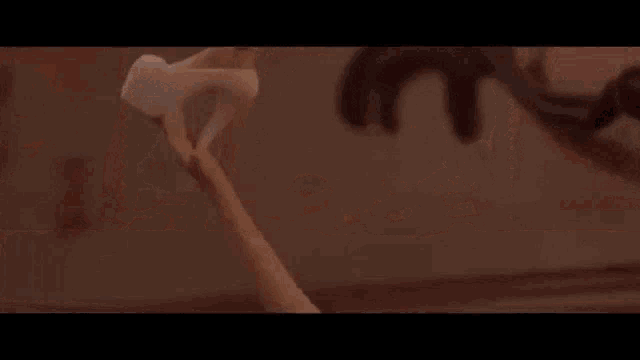 a girl is laying on the floor in a pink bedroom .