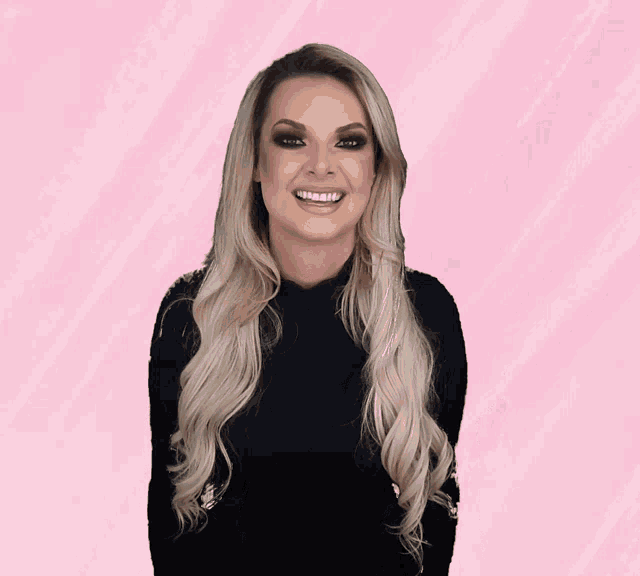a woman in a black shirt is laughing with her mouth open