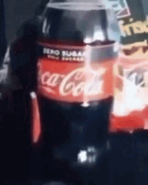 a close up of a bottle of coca cola on a table