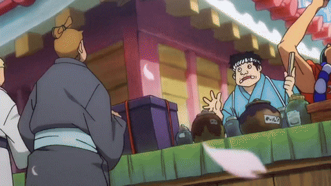 a man in a kimono stands behind a counter holding a jar that says ' a ' on it