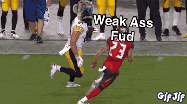 a football player with the number 23 on his jersey is running towards another player