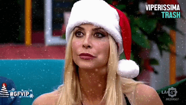 a woman wearing a santa hat with the words viperissima trash written on the bottom