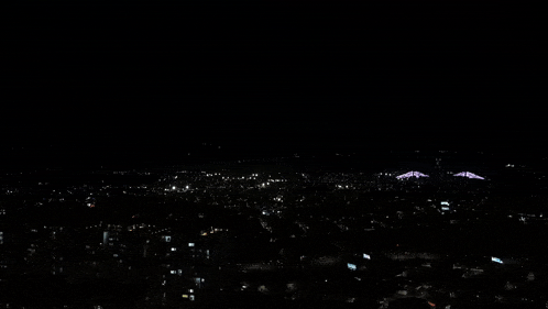an aerial view of a city at night with a lot of lights on