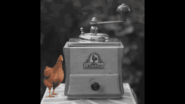 a chicken standing next to a coffee grinder that says leinwartz on it