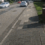 a row of cars parked on the side of a road
