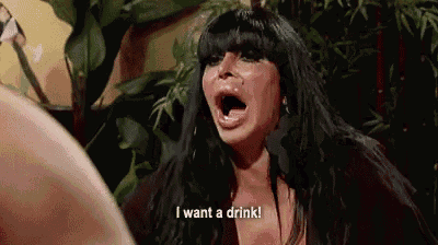 a woman is screaming with her mouth open and says `` i want a drink '' .
