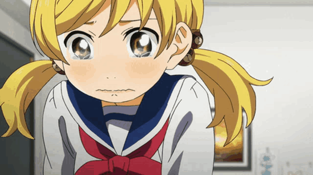a girl with blonde hair and a sailor uniform is looking at the camera
