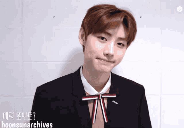 a young man in a suit with a bow tie and the words hoonsunarchives written on the bottom