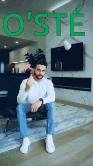 a man is sitting in a chair with the word o ' ste written above him