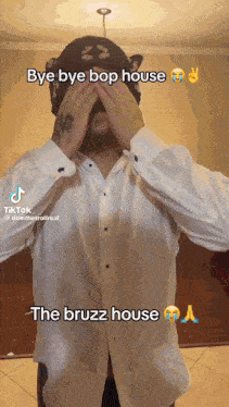 a man in a white shirt is covering his eyes with his hands and the words bye bye bop house the bruzz house are above him