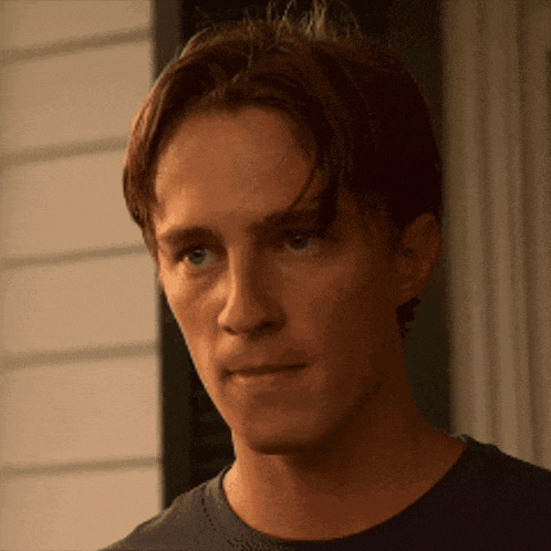 a close up of a man 's face with a slight smile on his face